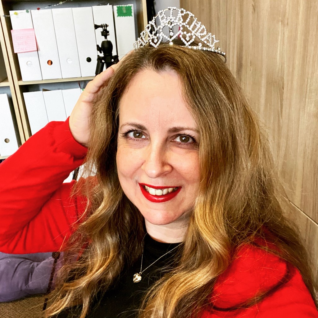 Charlotte Millington wearing a birthday tiara and red jacket